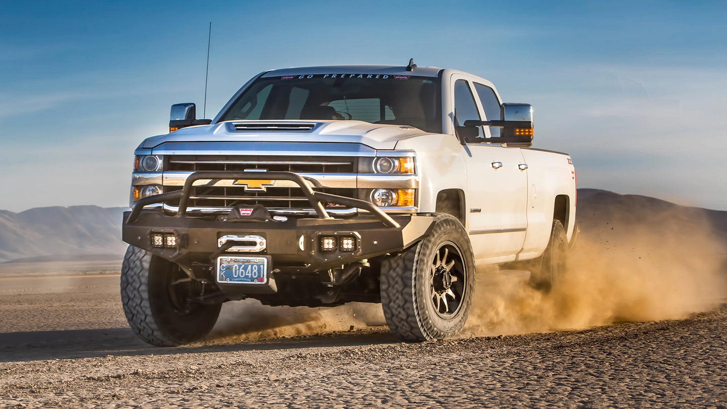 WARN Ascent Prerunner Grille Guard Tube for 2011-2018 Ram 2500/3500 front bumper shown on a dry lakebed