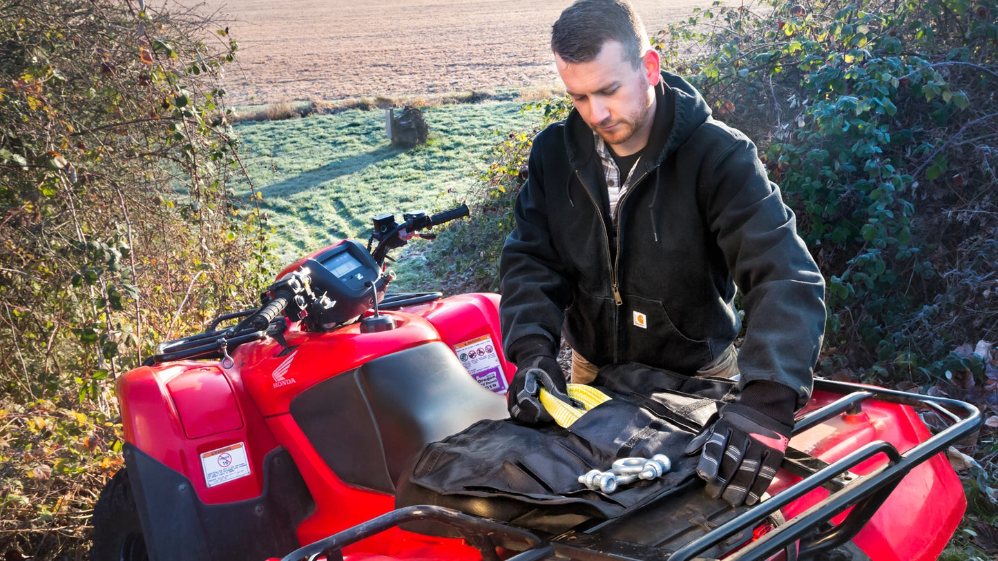 WARN Tool Roll Recovery Kit winch rigging kit shown in an open field